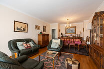 This spacious 2-bedroom apartment, featuring 2 terraces, a private garage box, and a parking space, is located on the third floor of a well-maintained residential building.

LAYOUT:
The entrance hall leads to a bright living room with a dining area and a 