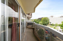 This spacious 2-bedroom apartment, featuring 2 terraces, a private garage box, and a parking space, is located on the third floor of a well-maintained residential building.

LAYOUT:
The entrance hall leads to a bright living room with a dining area and a 